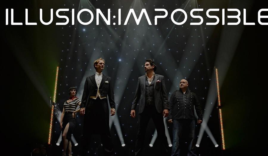 A post for illusion impossible. Men in suits standing on a stage.