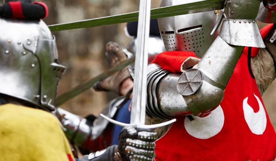 knights in armour fighting with swords