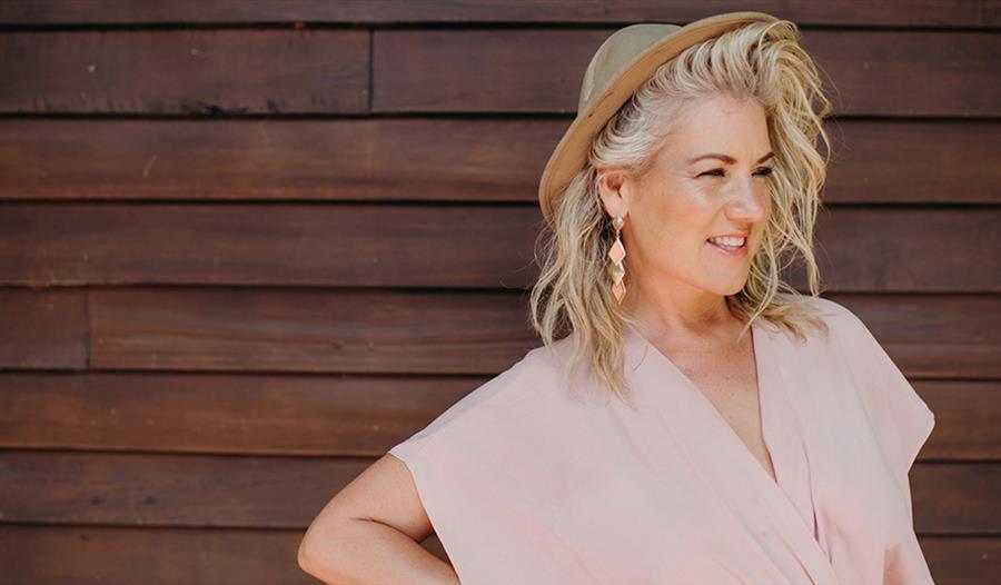 Lucinda Light smiling wearing a pink dress