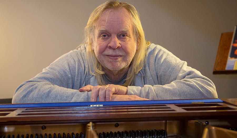 Rick Wakeman sitting at a piano