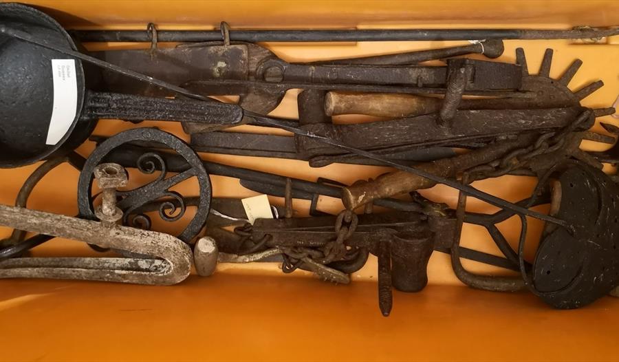 yellow museum box full of iron objects