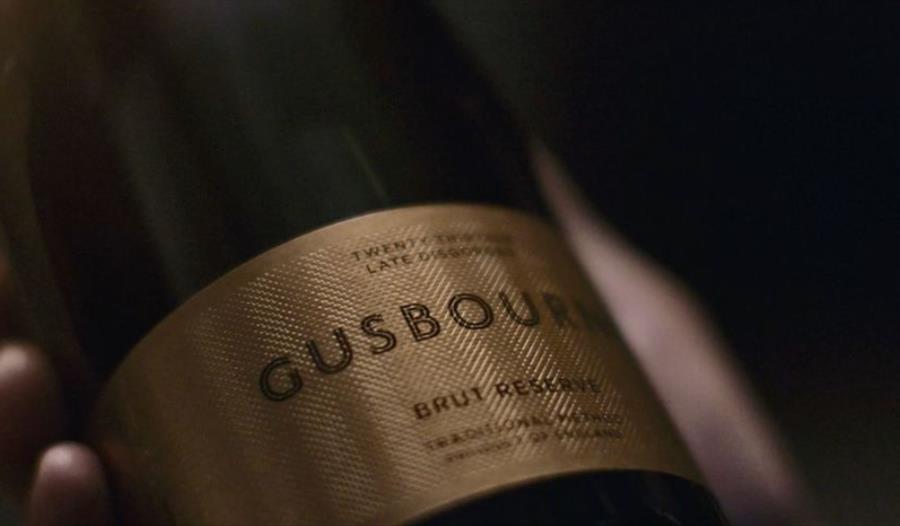 Close up photo of a gold Gusbourne Estate logo.