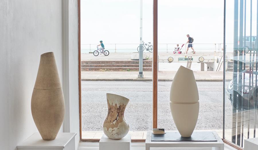 ceramics in front of a window with street scene.