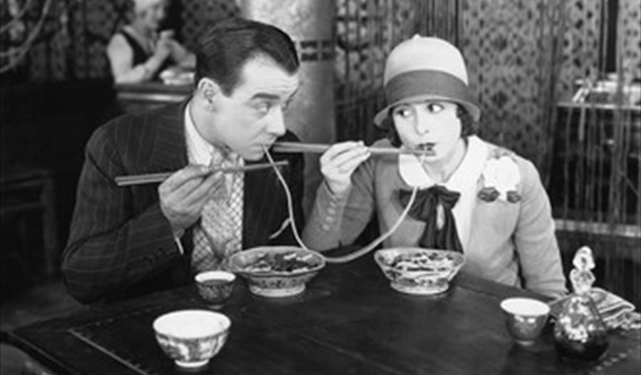 Old fashioned photo of a man and woman eating