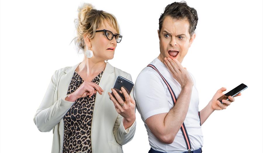 man and women checking their phones in disbelief
