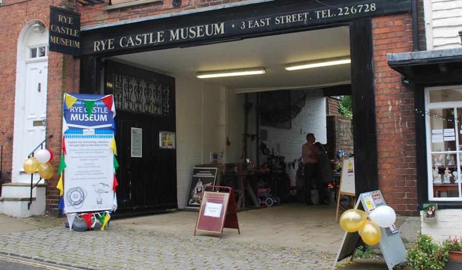 exterior of Rye Castle Museum, with balloons and display boards.