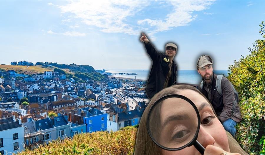 Three people overlooking Hastings’ rooftops and coastline during a Murder Mystery Adventure