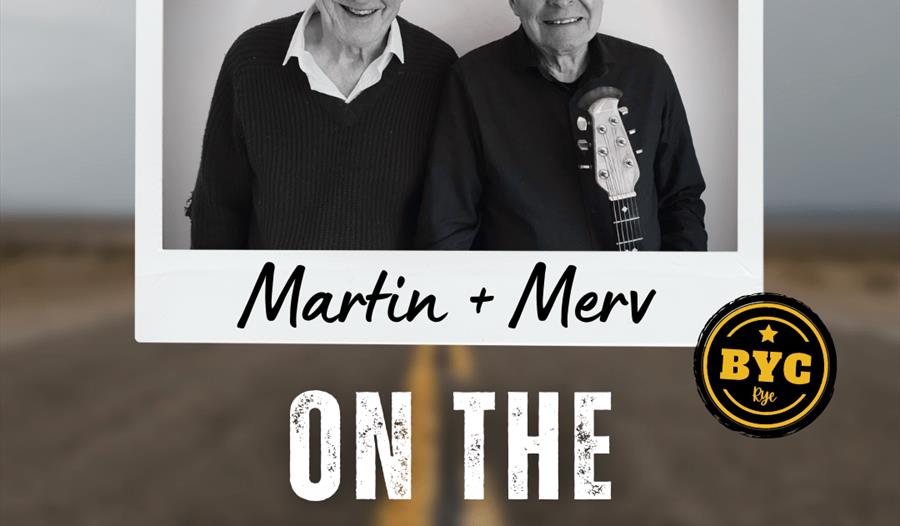 Poster with photograph of two white men, one with guitar, blurred background image of a road. Text reads "Martin & Merv on the road again".