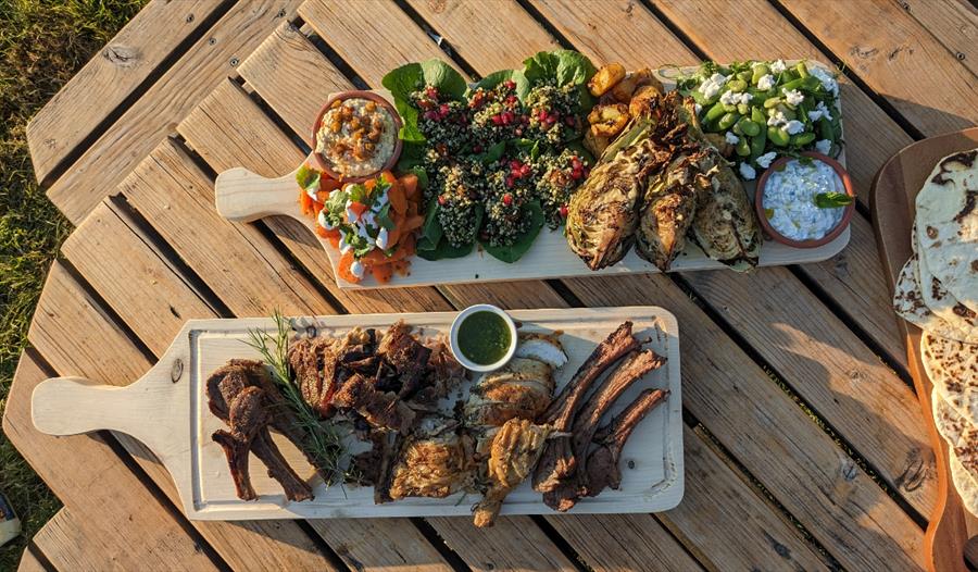 platters of food on a picnic bench