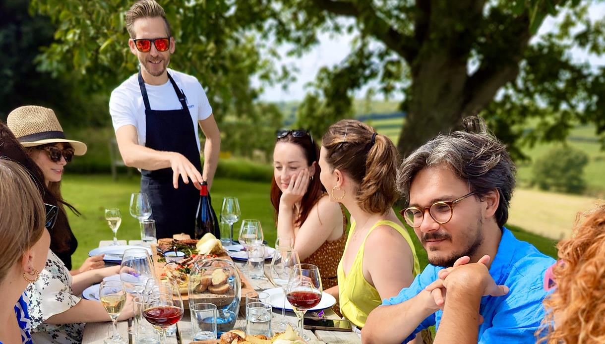 Vine + Country Wine Tours, guest seated around long al fresco table