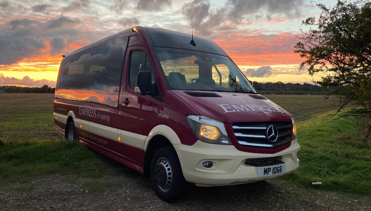 Empress Coach vehicle (mini bus) pictured in front of a sunset