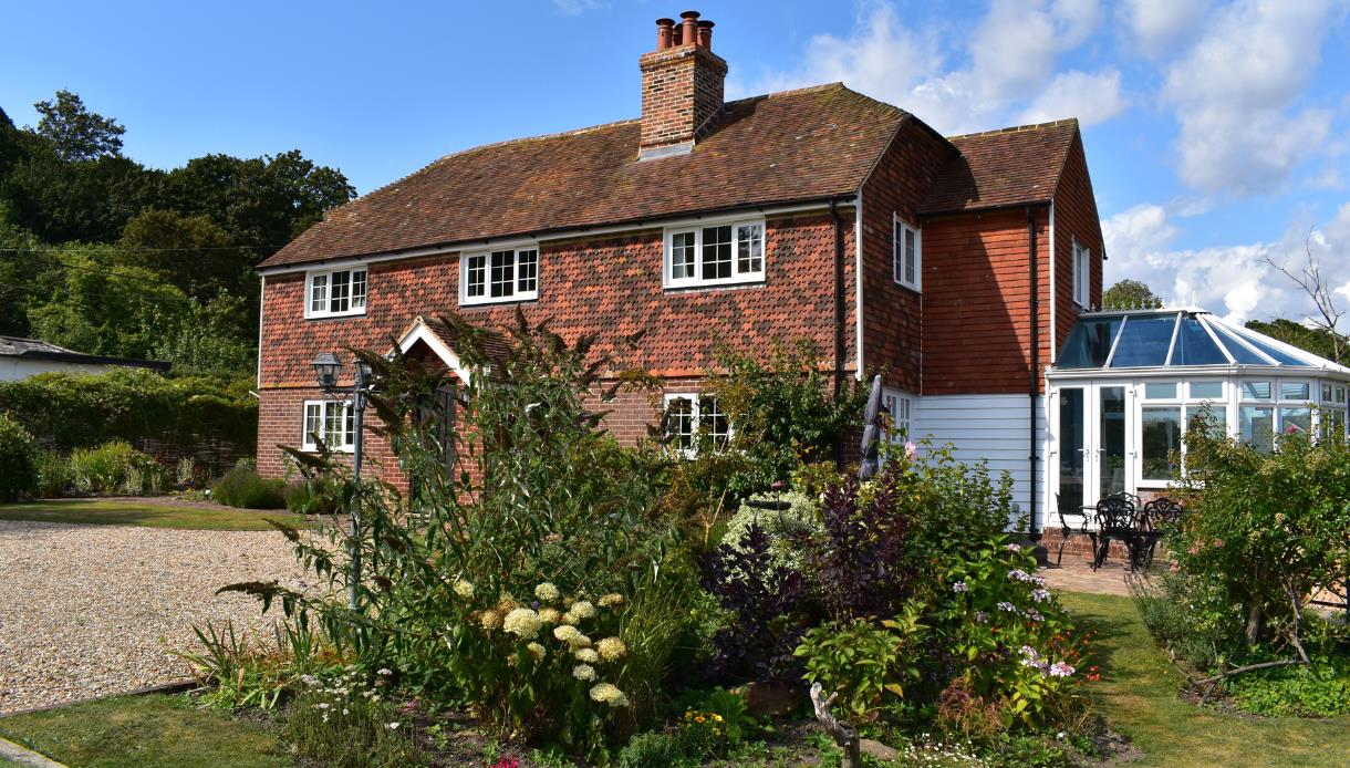 Traditional countryside holiday cottage with landscaped gardens at Rye & Beyond Holiday Cottages.