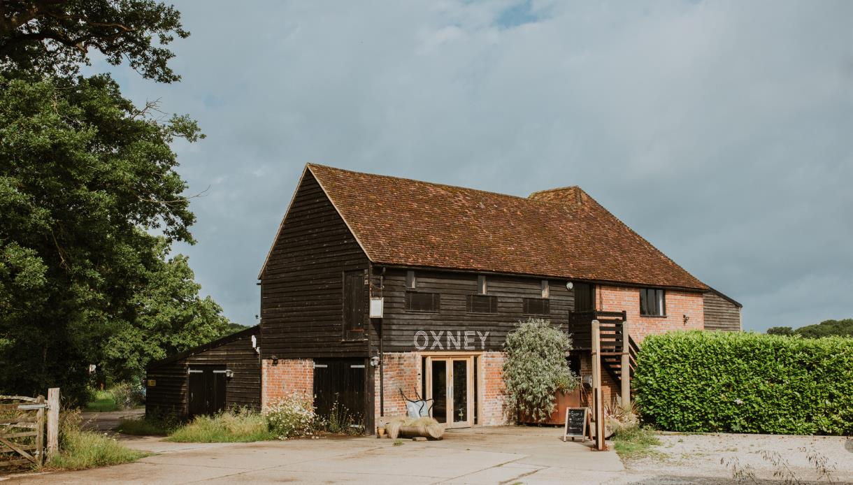 Historic barn at Oxney Organic Estate, home to the vineyard's tasting and visitor experience.