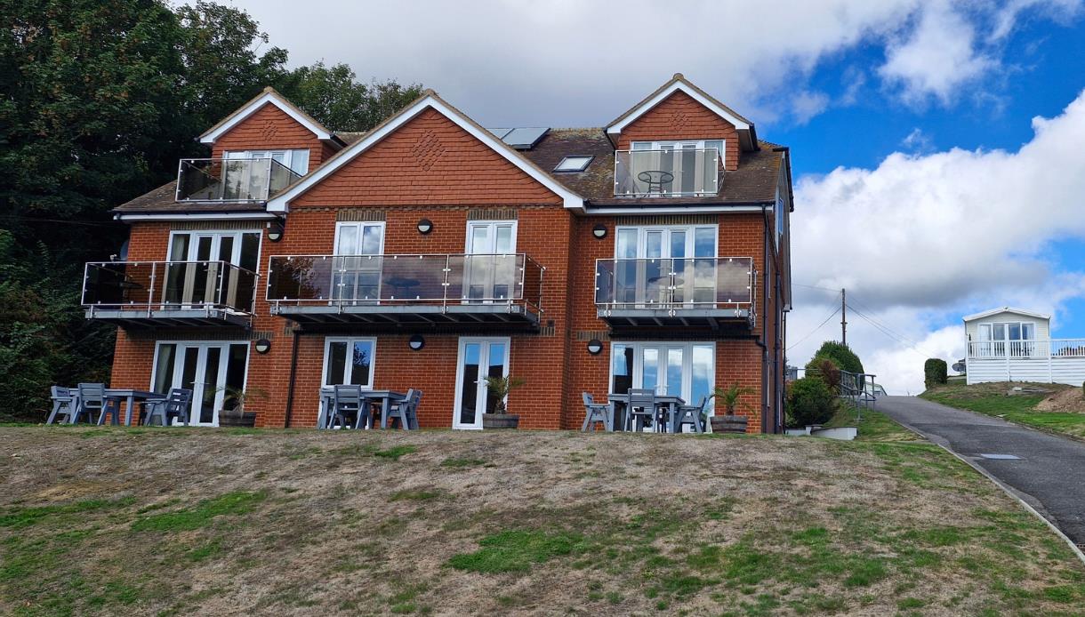 Modern holiday apartments at Rocklands Holiday Park with private balconies and outdoor seating.