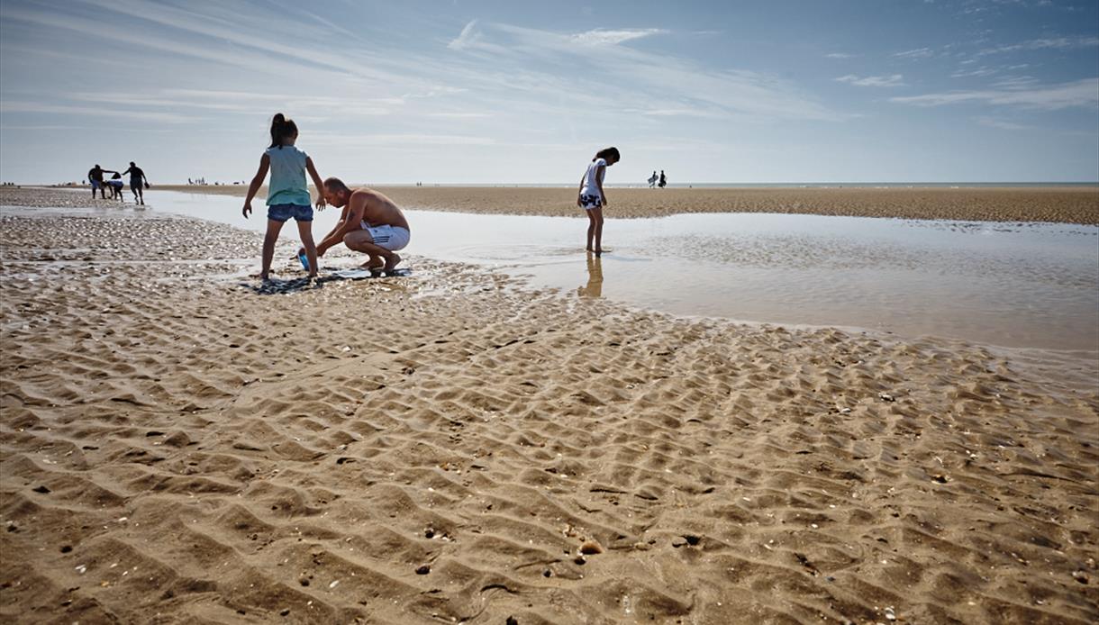 Children playing at low tide on Camber Sands