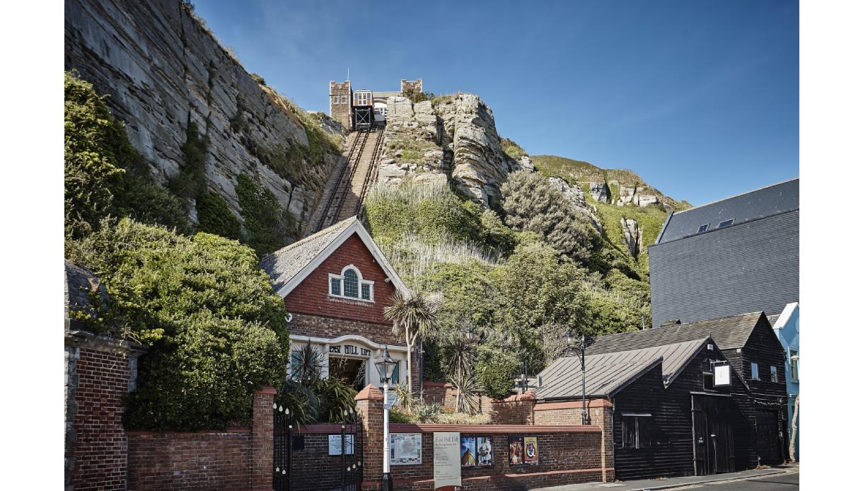 photograph of the east hill from the lower station. Shows brick building at the bottom of funicular railway cut into cliff.