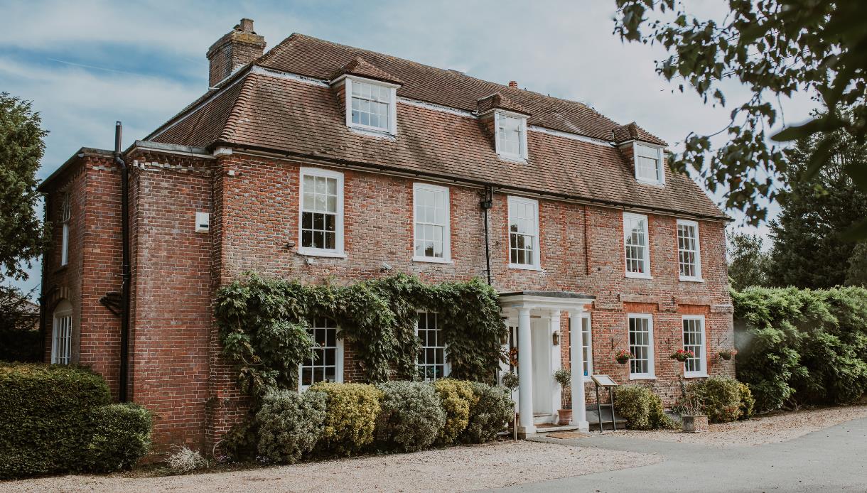 Flackley Ash Hotel near Rye, a large red-brick Georgian-style building with ivy and white entrance columns