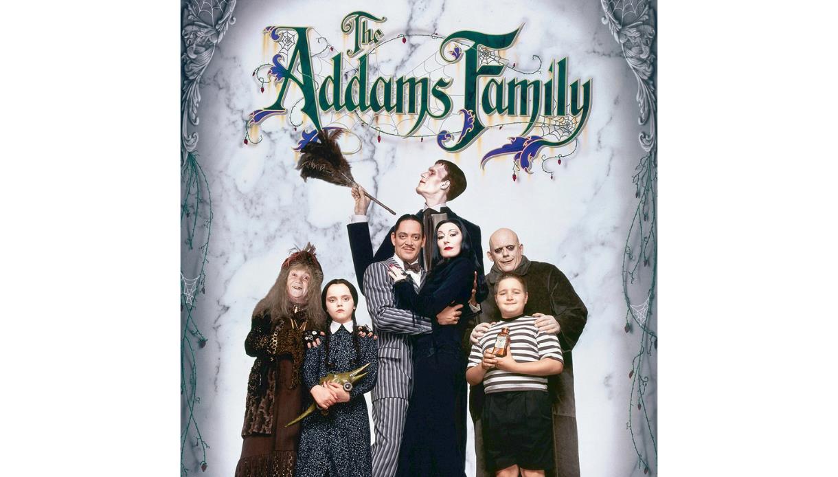 Promotional image for The Addams Family featuring the eccentric family posed beneath the title artwork.