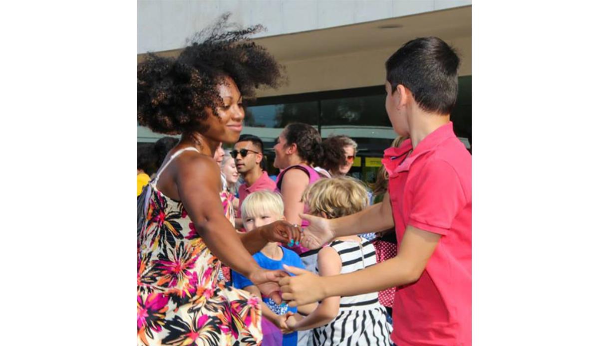 People of different ages dancing together outside the De La Warr Pavilion at the “Let’s Move and Dance Through the Decades” event.