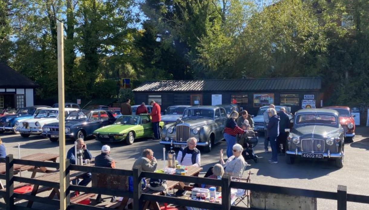 Austin Counties Car Rally with classic vintage cars on display as visitors gather outdoors in sunny weather.