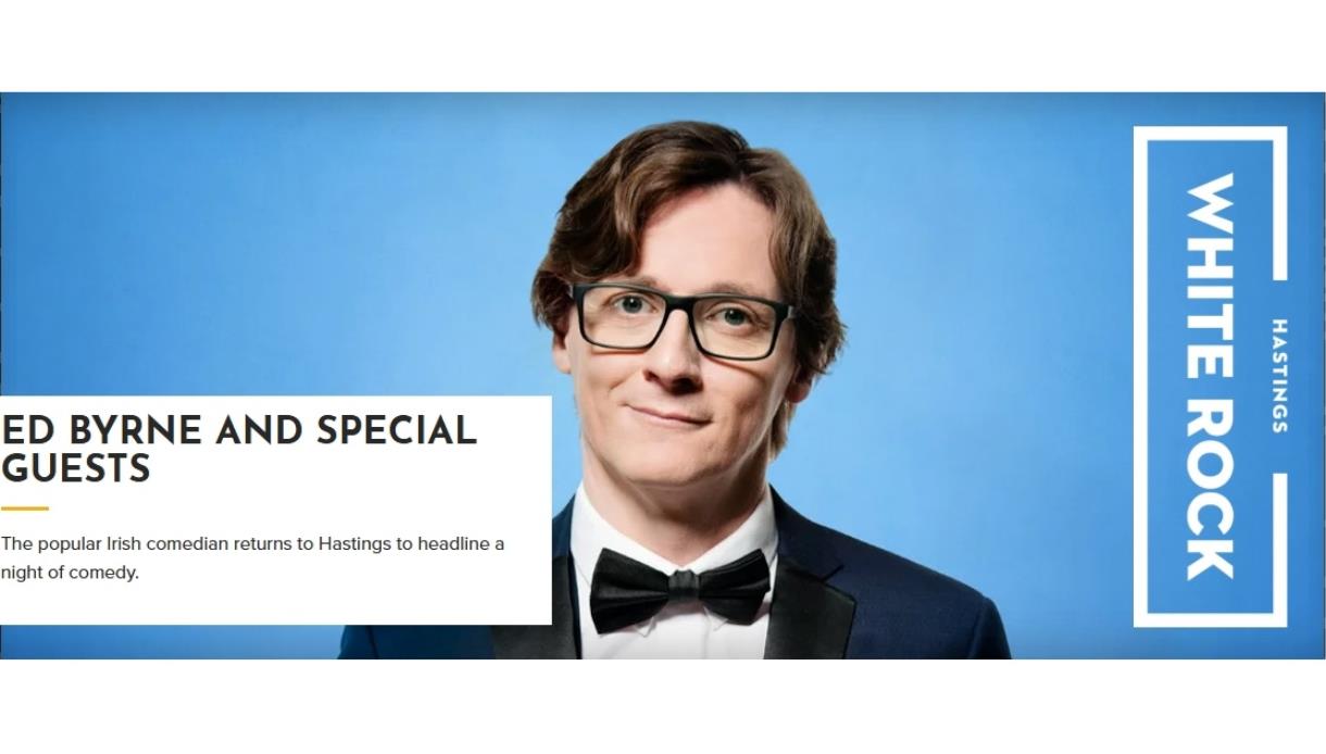 Promotional image for a comedy show at White Rock Hastings, featuring a suited performer on a blue background with event text