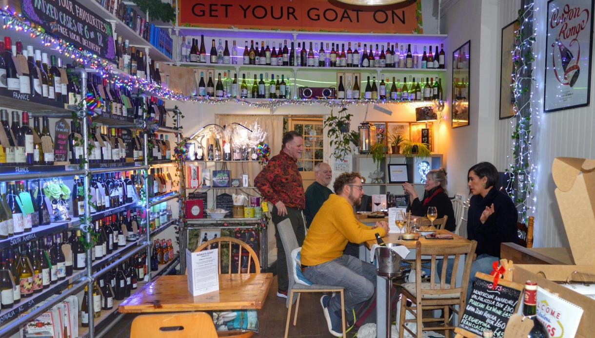 Copilot said:

Noah’s Goat wine bar in Hastings, with shelves of wine bottles and customers enjoying drinks in a cosy setting