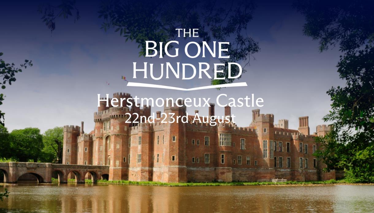 Herstmonceux Castle reflected in its moat, promoting The Big One Hundred celebration on 22 to 23 August.