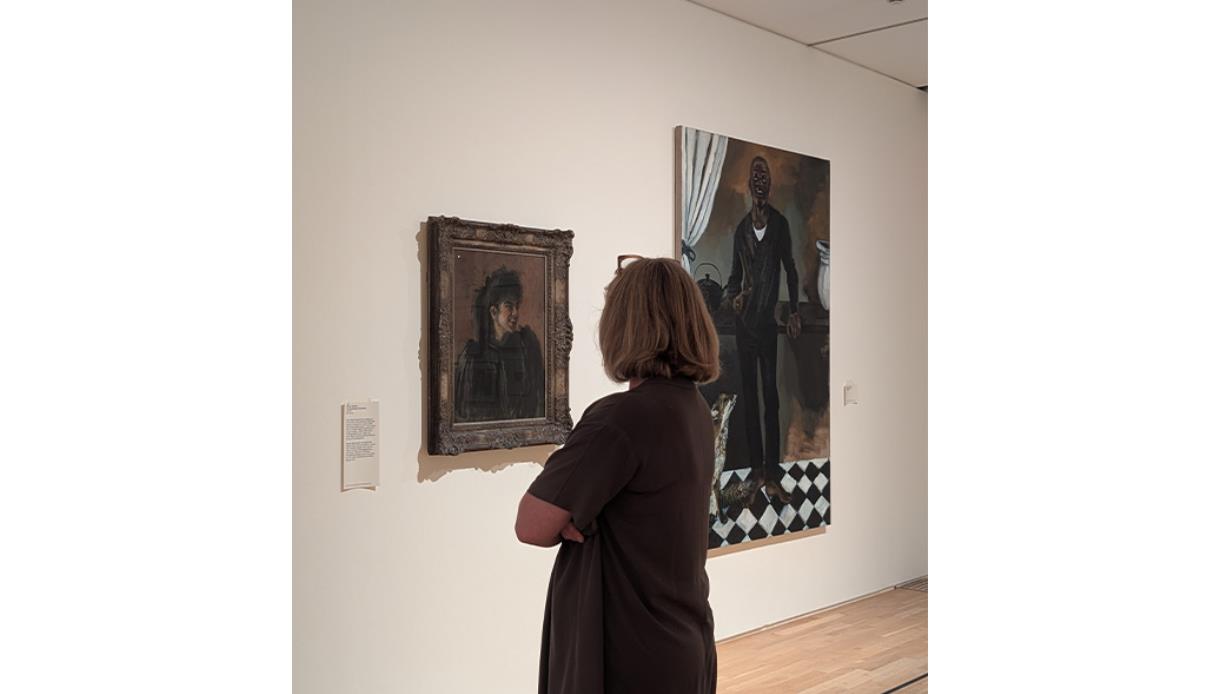 Visitor viewing paintings during a relaxed morning exhibition visit at De La Warr Pavilion gallery.