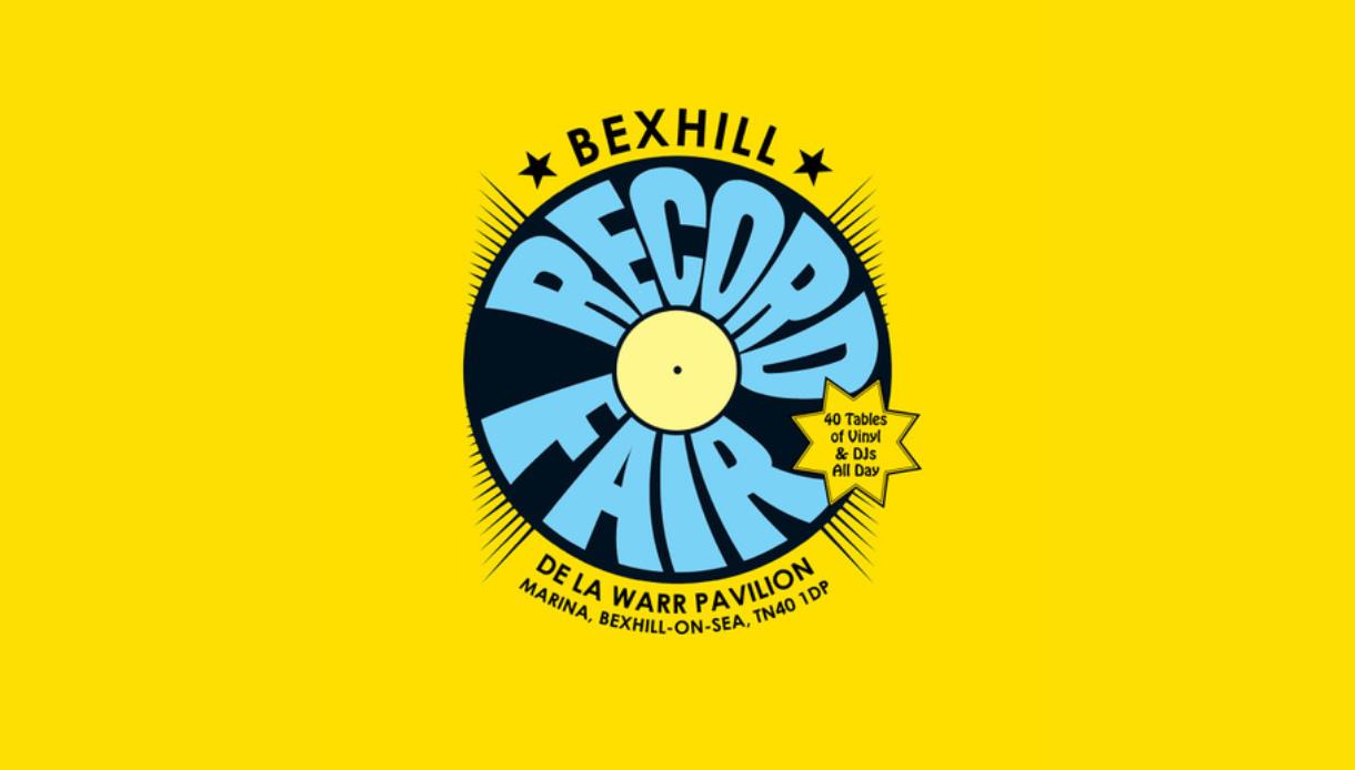 Bright yellow poster for Bexhill Record Fair with vinyl graphic, De La Warr Pavilion, “40 tables of vinyl & DJs all day.”