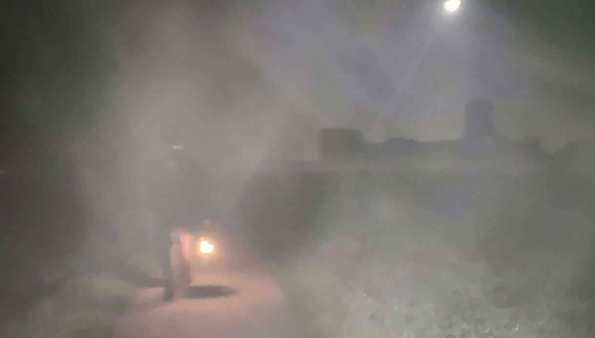 Foggy night scene at Pevensey with a costumed figure holding a lantern during Talking History event.