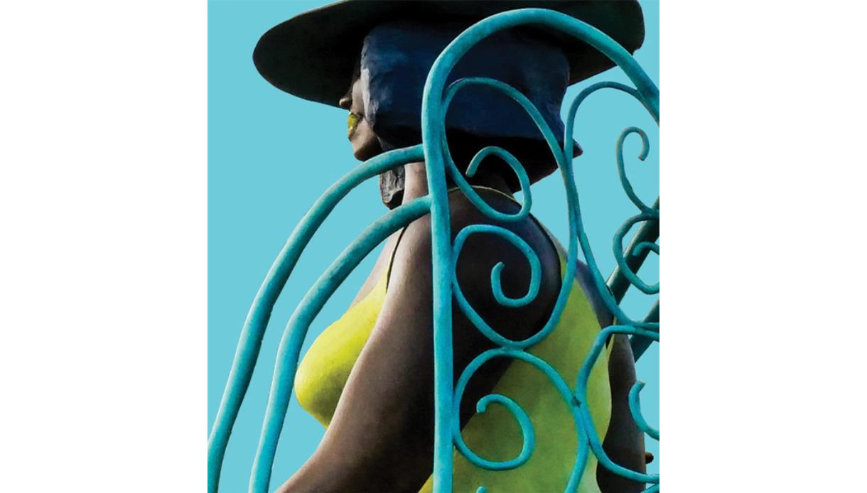 Sculptural figure with flowing, curled metal forms against a blue backdrop, promoting MASS, a celebration of 3‑D art at De La Warr Pavilion.