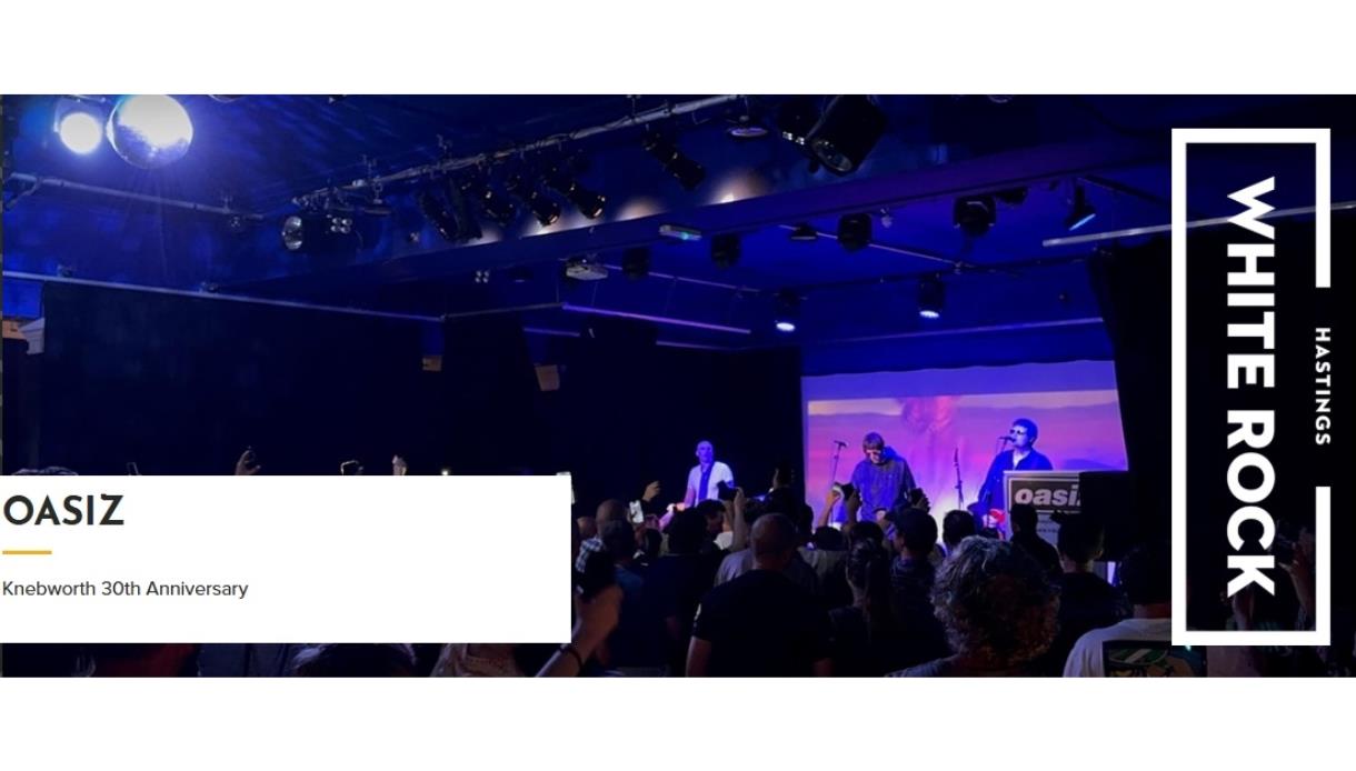 Live gig image for Oasiz at White Rock Theatre, showing a tribute band performing on stage to a packed audience under blue lights.