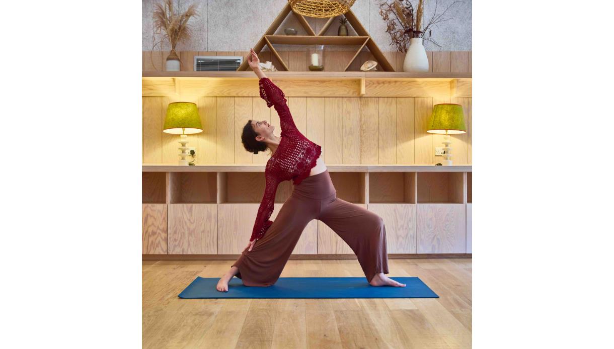 Participant practising yoga on a mat during the Sturgeon Moonrise Yoga experience at The Gallivant.