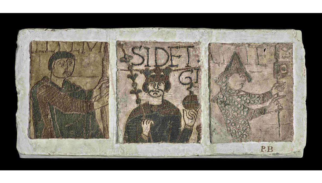 Cast replica panel inspired by the Bayeux Tapestry, showing medieval figures and decorative Norman artwork.