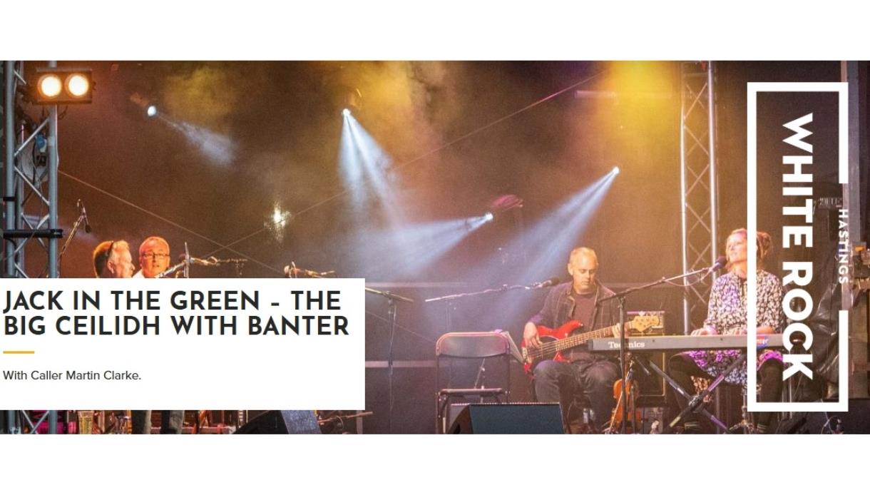 Musicians performing on a lit stage with text promoting ‘Jack in the Green – The Big Ceilidh with Banter’ at White Rock