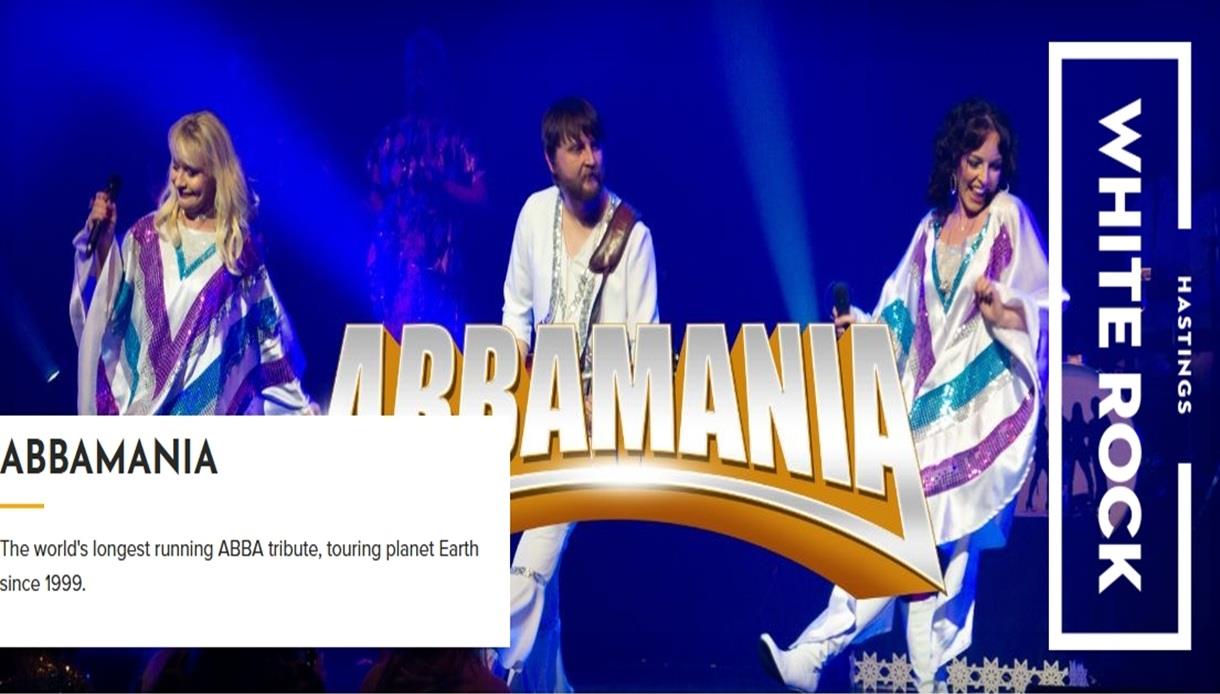 Poster for ABBAMANIA at White Rock Hastings, showing ABBA tribute performers on stage in bright costumes under blue lights.
