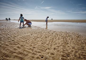 Children playing at low tide on Camber Sands