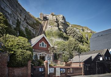 photograph of the east hill from the lower station. Shows brick building at the bottom of funicular railway cut into cliff.