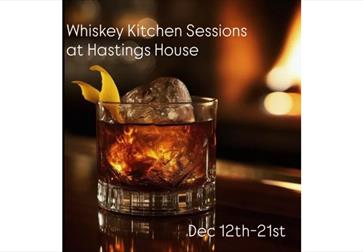 Glass of whiskey with ice and orange peel in front of a fire, text reads Whiskey Kitchen Sessions Dec 12–21.