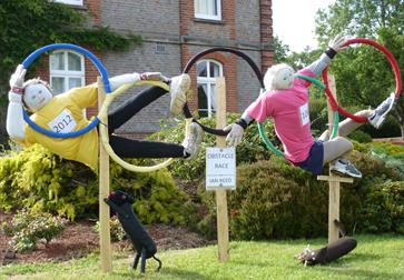 Scarecrows in Olympic hoops at Battle Scarecrow Festival