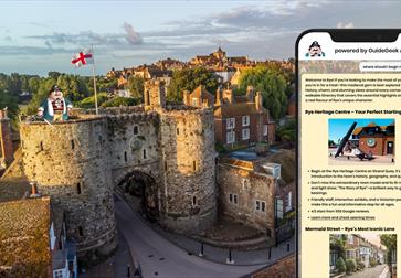 scenic aerial view of Rye, a historic town in East Sussex, England. The foreground shows the medieval stone gateway known as Landgate, with two round