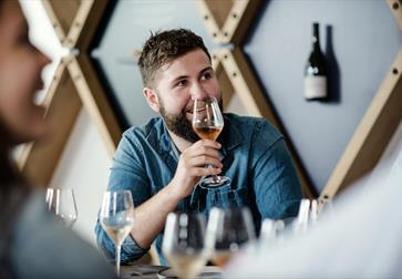man tasting rose wine.