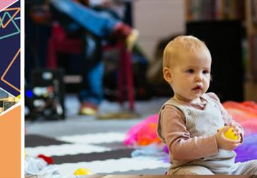 baby sat on the floor holding a yellow ball