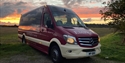 Empress Coach vehicle (mini bus) pictured in front of a sunset