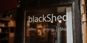 Entrance sign for BlackShed Gallery, framing studio and shop in Robertsbridge.