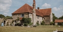 Historic Wickham Manor buildings at Charles Palmer Vineyards, surrounded by landscaped gardens.