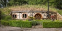 Unique hobbit-style accommodation at Oastbrook Vineyard surrounded by landscaped gardens.