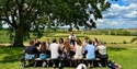 Guided vineyard picnic experience with Vine & Country Tours, overlooking rolling Sussex countryside.