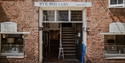 Entrance to Rye Pottery shop with historic brick frontage in the centre of Rye.