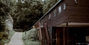 Exterior of BlackShed Gallery, a modern timber-clad gallery building set among woodland and countryside.